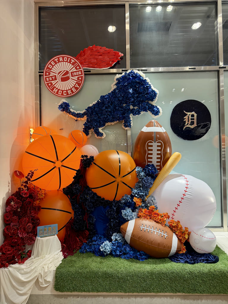 Detroit sports installation with oversized basketballs, a football, and a balloon lion