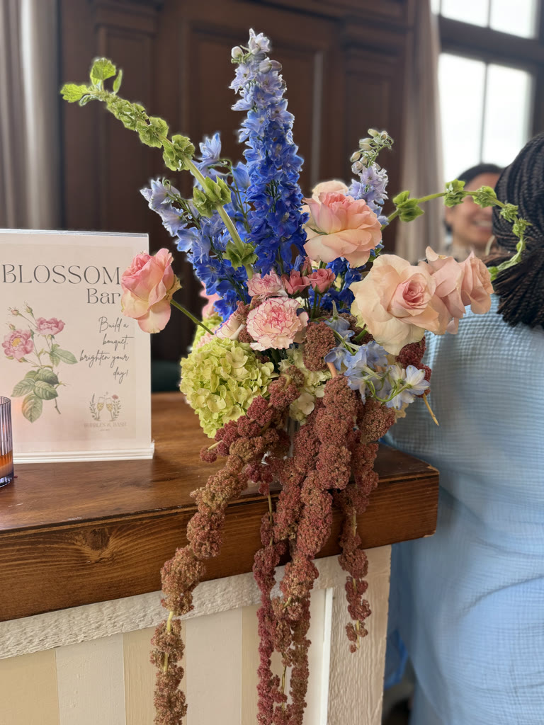 Blossom Bar floral station with delphinium, roses, and hydrangea