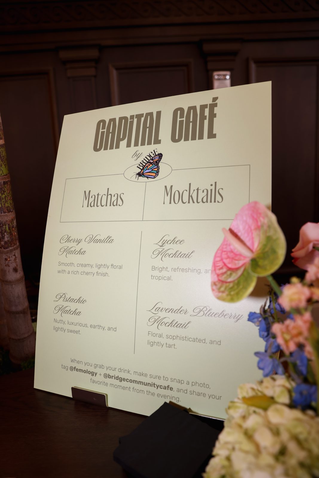 Capital Cafe matcha and mocktail menu card beside anthurium florals