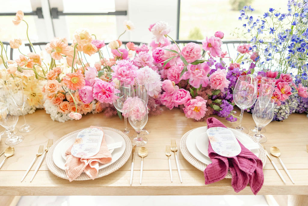 Pink and peach ombre tablescape of fresh garden roses with gold flatware