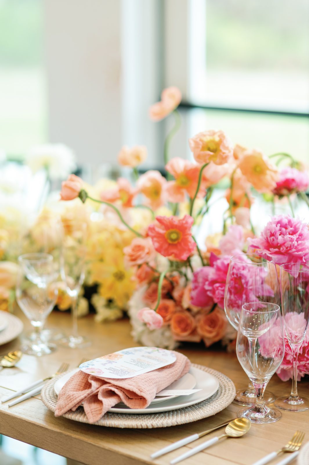 Pastel rose and ranunculus tablescape with blush napkins