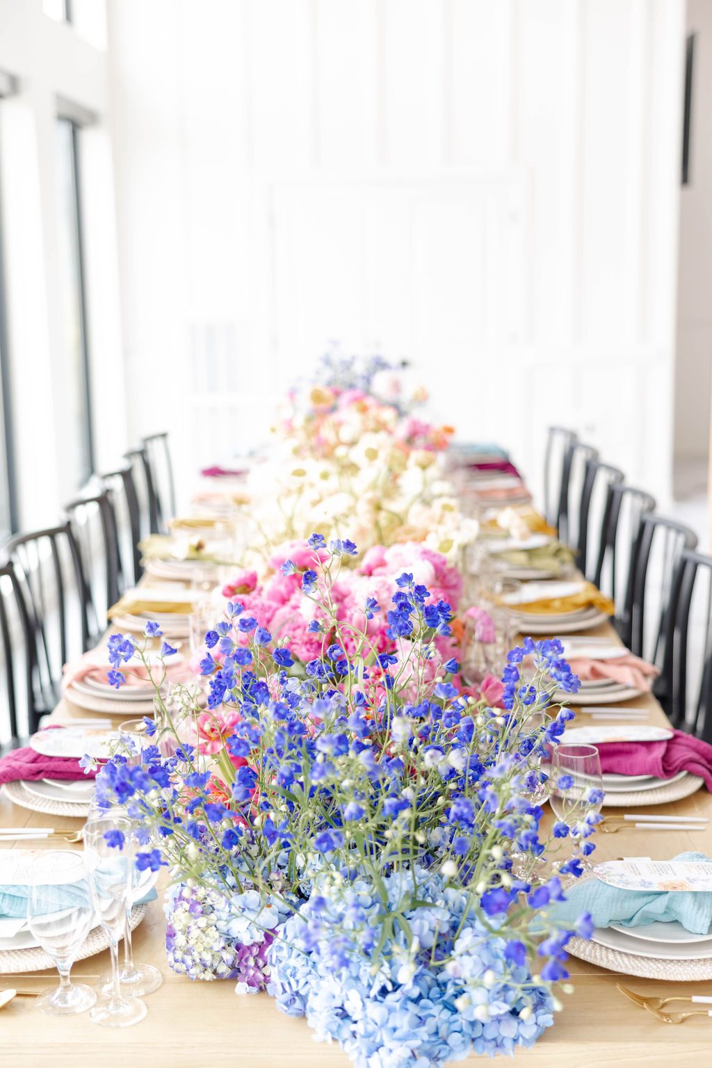 Blue delphinium centerpiece running down a long dining table
