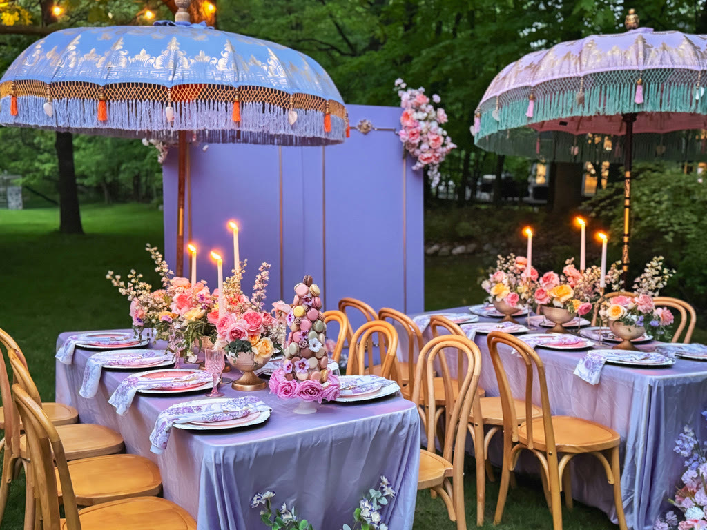 Lavender garden dinner under fringed parasols, lit by tapers at dusk