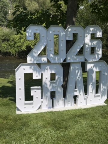 Giant 2026 GRAD marquee letters on a lawn