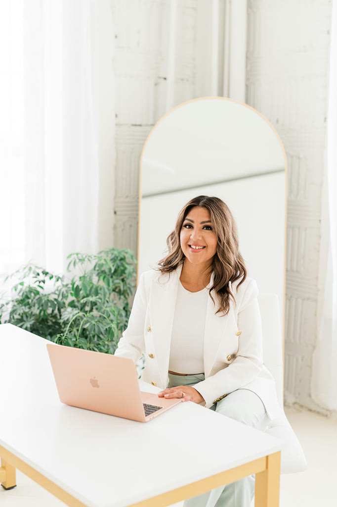 Karla Robles working at a white desk in the KRP studio